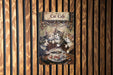 a cat cafe sign hanging on a wooden wall