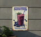 a blueberry smoothie sign hanging on the side of a building