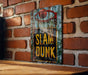 a picture of a slam dunk sign hanging on a brick wall