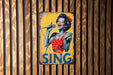 a sign on a wooden wall that says sing
