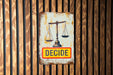 a sign on a wooden wall that says decide