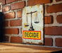 a sign on a brick wall that says decide