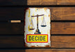a sign on a wooden wall that says decide