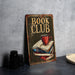 a book club sign sitting on top of a table