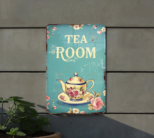 a tea room sign hanging on the side of a building