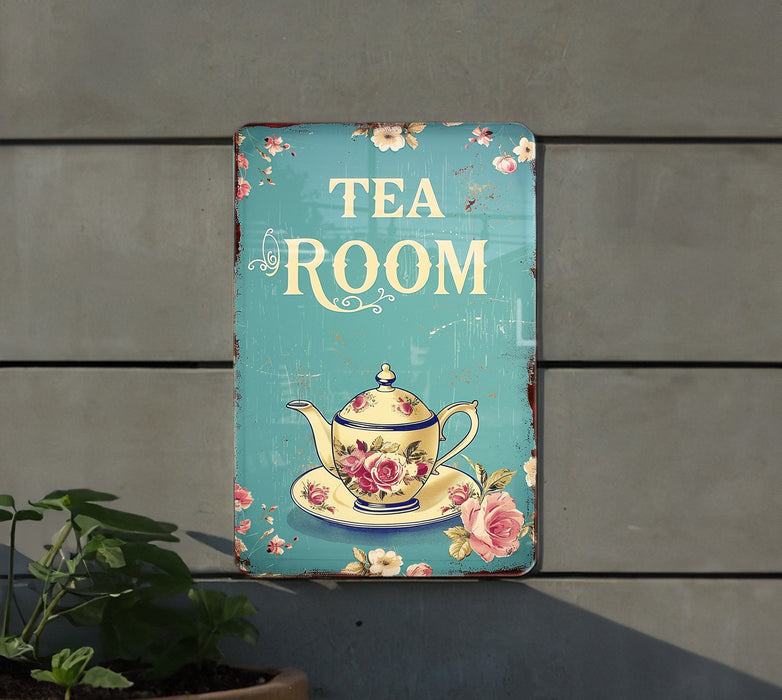 a tea room sign hanging on the side of a building