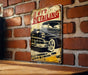 a vintage metal sign on a brick wall