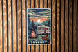 a poster of a camper sitting next to a fire