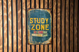 a sign on a wooden wall that says study zone