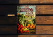 a fresh produce stand sign hanging on a wooden wall
