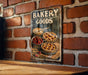 a sign on a brick wall that says bakery goods