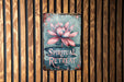 a metal sign with a pink flower on it