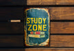 a sign on a wooden wall that says study zone