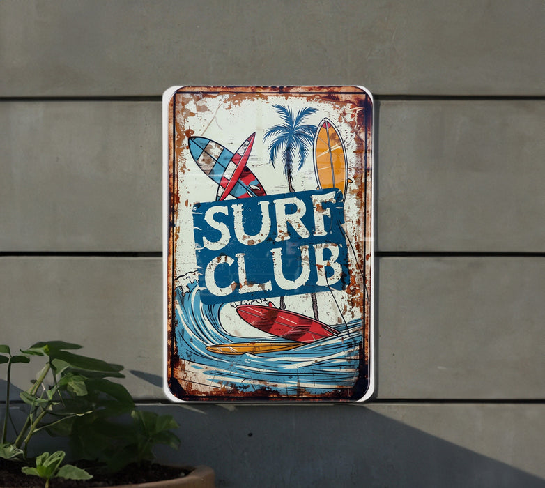 a rusty surf club sign hanging on the side of a building