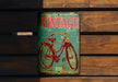 a vintage bicycle sign on a wooden wall