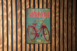 a vintage bicycle sign on a wooden wall