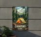 a camping store sign hanging on the side of a building