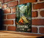 a picture of a camping store hanging on a brick wall