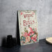 a wedding bells sign next to a pair of binoculars
