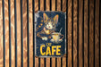 a cat cafe sign on a wooden wall