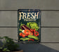 a fresh produce sign hanging on a wall
