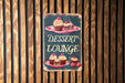 a sign that says dessert lounge with cupcakes on it