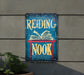 a sign reading nook hanging on the side of a building