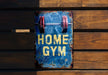 a sign that says home gym hanging on a wooden wall