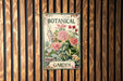 a botanical garden poster hangs on a wooden wall