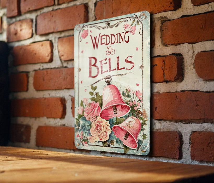 a wedding bells sign on a brick wall