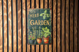 a herb garden sign hanging on a wooden wall