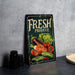 a fresh produce sign sitting on a table