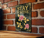 a sign on a brick wall that says stay positive