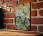 a bike trail sign on a brick wall