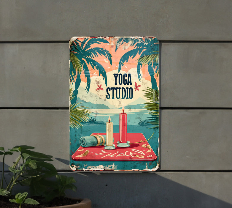 a yoga studio sign hanging on the side of a building