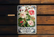 a botanical garden sign hanging on a wooden wall