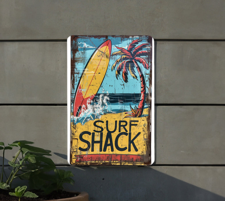 a surf shack sign hanging on the side of a building