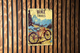 a bike trails sign on a wooden wall