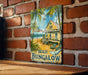 a picture of a beach bungalow sign on a brick wall