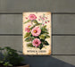 a metal sign with pink flowers on it