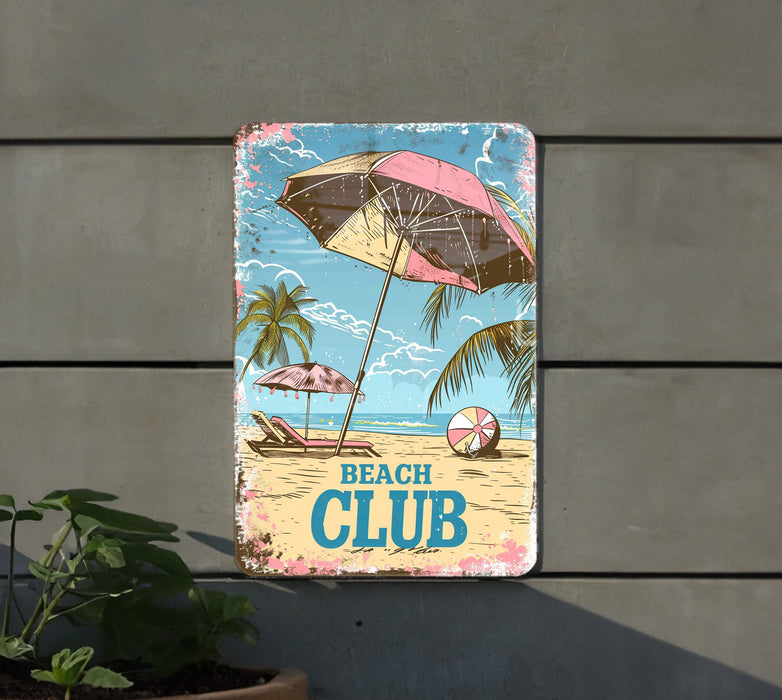a beach club sign hanging on the side of a building