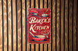 a sign on a wooden wall that says baker's kitchen