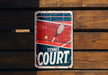 a tennis court sign on a wooden wall