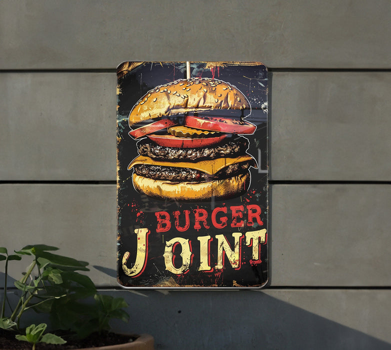 a burger joint sign hanging on the side of a building