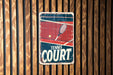 a tennis court sign on a wooden wall