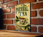 a sign on a brick wall with a cup of tea