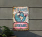 a sign on the side of a building that says travel dreams