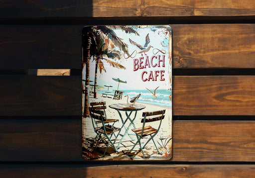 a beach cafe sign on a wooden bench