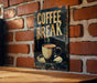 a sign on a brick wall that says coffee break