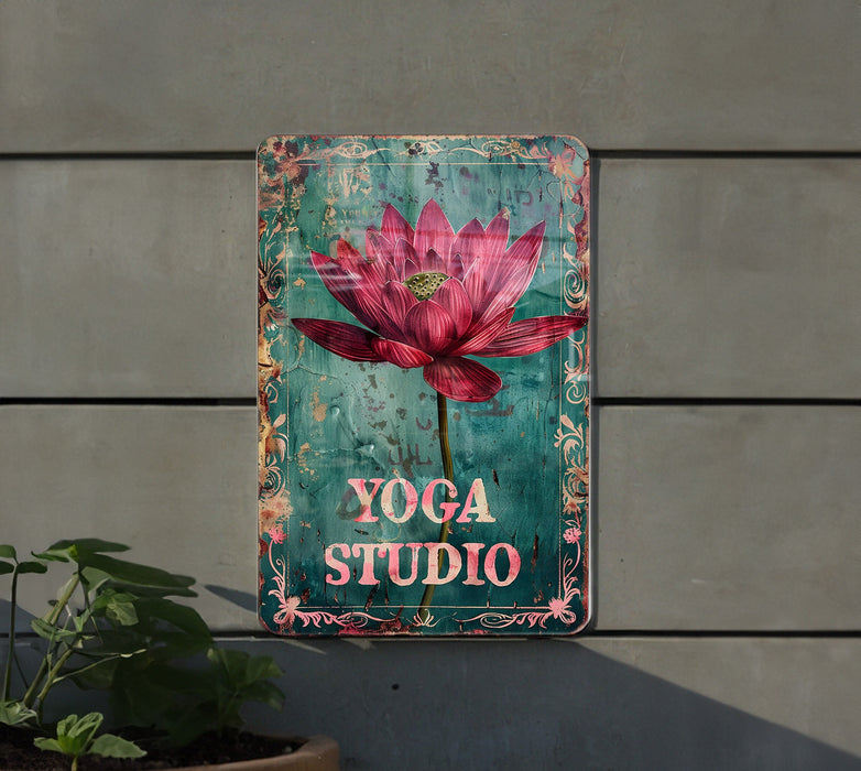 a sign that says yoga studio with a pink flower on it